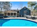 Relaxing backyard with a private in-ground pool, deck, and screened-in porch at 4970 Lost Mountain Nw Trce, Kennesaw, GA 30152