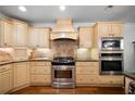 Well-equipped kitchen with stainless steel appliances, custom cabinets, and tile backsplash at 4970 Lost Mountain Nw Trce, Kennesaw, GA 30152
