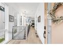 Bright entryway featuring hardwood floors, white walls, a modern railing and lots of natural light from the nearby windows at 10862 Serenbe Ln, Chattahoochee Hills, GA 30268