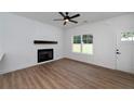 Inviting living room with fireplace, wood mantel, and white shiplap accent wall and wood floors at 1534 River Rock Trce, Woodstock, GA 30188