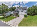 Two story traditional home boasting a well-manicured lawn and long driveway at 3906 Elm Trace Ct, Loganville, GA 30052