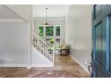 Bright foyer with tiled floors, staircase, and views into the living area at 4204 Woodfare Nw Ln, Kennesaw, GA 30152