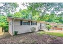 Angled view of home's facade showing entry porch, brickwork, and carport at 1538 Belva Ave, Decatur, GA 30032