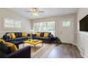 Bright living room featuring hardwood floors, large windows, and stylish decor at 1538 Belva Ave, Decatur, GA 30032