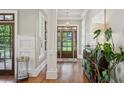 Bright foyer featuring hardwood floors, a decorative light fixture, and views of the front yard at 1589 Trentwood Ne Pl, Brookhaven, GA 30319