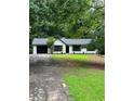Charming single-story home with a black-trimmed garage and black-framed windows, surrounded by lush greenery at 168 Park Ln, Dallas, GA 30157