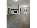 A spacious living room featuring a stone fireplace, modern lighting, and stylish flooring at 168 Park Ln, Dallas, GA 30157
