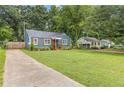 Blue home with a spacious front yard and a long driveway leading up to the residence at 2728 Mcafee Rd, Decatur, GA 30032