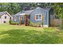 Quaint blue home featuring neat landscaping, wooden shutters, and a covered porch entry at 2728 Mcafee Rd, Decatur, GA 30032
