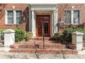 Inviting entryway featuring brick steps, white pillars, and a bright red front door at 733 Frederica Ne St # 7, Atlanta, GA 30306
