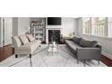 Bright living room with modern furnishings, a fireplace, and large windows at 804 Whittington Sw Pkwy, Marietta, GA 30060