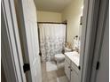 A clean bathroom featuring a shower with a patterned curtain, and a neutral color palette at 223 Sterling Brook Ln, Canton, GA 30114