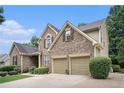 Beautiful exterior view of a two-story brick home with a two-car garage and manicured lawn at 223 Sterling Brook Ln, Canton, GA 30114