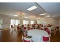 Elegant dining area featuring chandeliers, round tables, and comfortable seating creates a refined ambiance at 475 Mount Vernon Ne Hwy # C-220, Sandy Springs, GA 30328