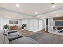 Finished basement with plank floors, a cozy seating area, and a modern entertainment center at 4908 Mill Brook Dr, Atlanta, GA 30338
