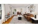 Bright living room with hardwood floors, modern decor, and a view into the dining room at 4908 Mill Brook Dr, Atlanta, GA 30338