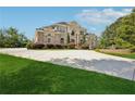 Spacious home with a circular driveway, manicured lawn, and tasteful landscaping at 5661 Rutland Trce, Lithonia, GA 30058