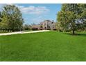 Large home surrounded by lush green lawn and mature trees at 5661 Rutland Trce, Lithonia, GA 30058