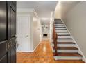 Welcoming entryway with hardwood floors, a staircase, and views into a light-filled living space at 1378 Sheffield Glen Ne Way, Atlanta, GA 30329