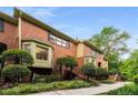 Attractive brick townhouse with bay windows, beautiful bushes and a stairway to the front entrance at 1378 Sheffield Glen Ne Way, Atlanta, GA 30329