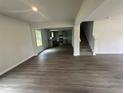 Open concept living room with stylish gray vinyl flooring, leading to the kitchen and staircase at 15 Fontana Ct, Covington, GA 30016