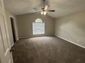 Spacious main bedroom featuring high ceilings, a ceiling fan, and plush carpeting at 2183 Ramblewood Cir, Decatur, GA 30035