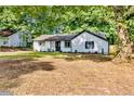 Inviting one-story home boasting a freshly painted exterior, complemented by mature trees, providing a serene setting at 373 Hemlock Dr, Lawrenceville, GA 30046
