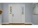 Interior front door with sidelights and fresh neutral paint and wood flooring at 2316 Fripp Overlook Nw, Acworth, GA 30101