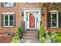 Close up of the front door and entryway with brick steps and black iron railing at 2316 Fripp Overlook Nw, Acworth, GA 30101