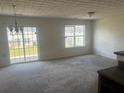 Bright living room with sliding glass doors and plenty of natural light from large windows at 730 Georgetown Ln, Jonesboro, GA 30236