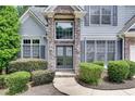 Inviting front entrance with stone columns, double doors, and manicured landscaping at 420 Gold Xing, Canton, GA 30114
