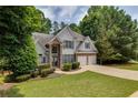 Beautiful two-story home featuring stone accents, lush landscaping, and a two-car garage at 420 Gold Xing, Canton, GA 30114
