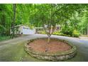 Spacious driveway and lush landscaping leading to a charming two-story home at 4211 Burnt Hickory Nw Rd, Marietta, GA 30064