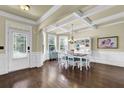 Elegant dining room features hardwood floors, coffered ceilings, and a chandelier above the dining table at 4315 Balsam Bark Dr, Cumming, GA 30028