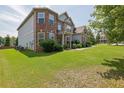 Two-story home with manicured front lawn and mature landscaping at 4315 Balsam Bark Dr, Cumming, GA 30028