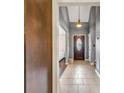 Inviting entryway with tiled floor and decorative front door, with a peek into the brightly-lit living room at 5485 Shirewick Ln, Lithonia, GA 30058