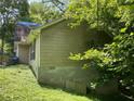 Exterior of home with green vinyl siding and cinder block foundation at 590 Killian Road Rd, Canton, GA 30114