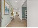 Inviting foyer with wood floors, decorative art, and views into the living spaces at 221 Paisley Way, Locust Grove, GA 30248