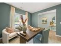 Stylish home office featuring a large desk, comfortable seating, and natural light at 221 Paisley Way, Locust Grove, GA 30248