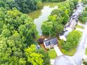 Aerial view of the property backing onto a tranquil lake surrounded by dense trees at 3229 Dunlin Lake Rd, Lawrenceville, GA 30044