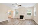 Inviting living room showcasing a fireplace, natural light, and sleek, modern flooring at 4130 Stonecypher Rd, Suwanee, GA 30024