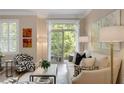Sunlit living room with a balcony view, neutral decor, and stylish patterned accents at 1055 Piedmont Ne Ave # 401, Atlanta, GA 30309