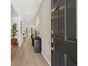 Inviting hallway with wood floors, light gray wallpaper, and modern decor at 229 Paisley Way, Locust Grove, GA 30248