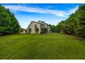 Expansive backyard with lush green lawn and mature trees offering privacy and plenty of space at 15 Saddlebrook Ct, Covington, GA 30016