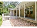 Covered front porch with white support columns and wood flooring at 3440 Wilson Rd, South Fulton, GA 30349