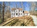 Inviting two-story home with a well-maintained yard and a classic architectural design at 5050 Brownwood Dr, Powder Springs, GA 30127
