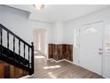 Entryway featuring hardwood floors, wainscotting and a white front door with decorative glass at 5050 Brownwood Dr, Powder Springs, GA 30127