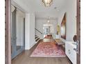Elegant home foyer with beautiful rug, hardwood floors, and modern lighting at 102 Grand Cres, Alpharetta, GA 30009