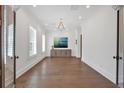 Spacious living room with dark hardwood floors, plantation shutters, and modern lighting at 102 Grand Cres, Alpharetta, GA 30009