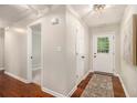 Inviting entryway with wood floors, neutral walls, and a stylish ceiling light fixture at 215 Nina Circle Cir, Locust Grove, GA 30248